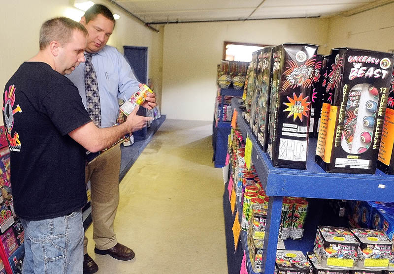 Co-owner Tim Bolduc, left, talks to customer David Godfrey about some of the products at Patriot Fireworks in Monmouth.