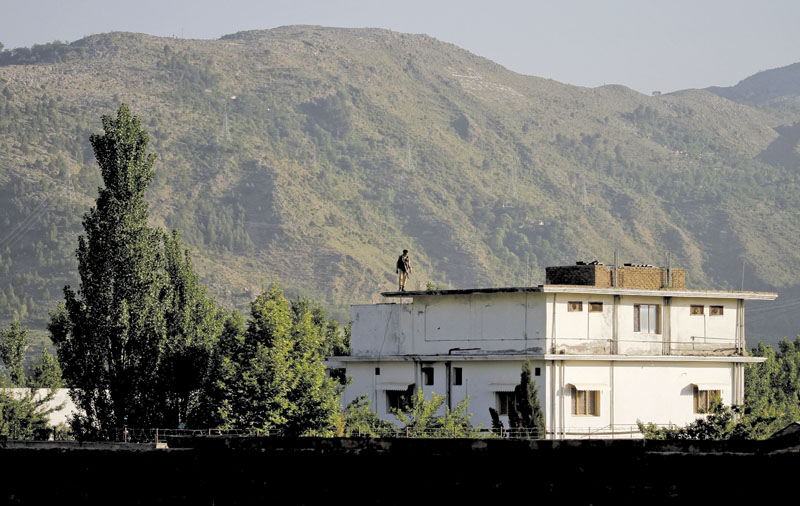 A Pakistan army soldier stands on top of the house where ial-Qaida leader Osama bin Laden lived in Abbottabad, Pakistan. Pakistan has convicted a doctor who helped the U.S. track down and kill bid Laden.