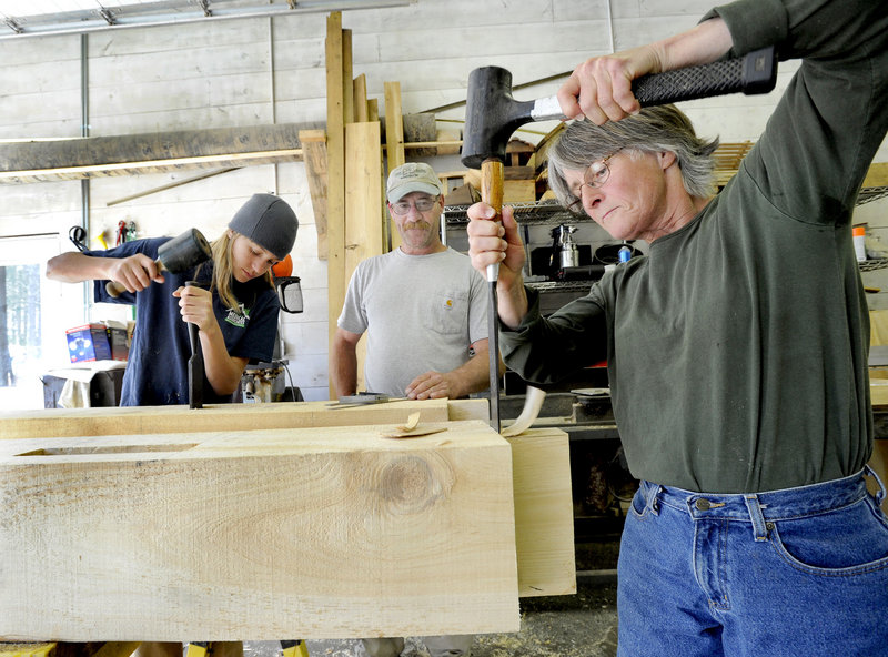 Bob Lear, middle, keeps his eyes on Hidden Valley Nature Center timber framing students Jane Conley, right, and Sebastian Crocetti.