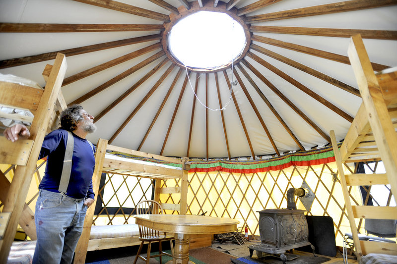 Tracy Moskovitz looks through a skylight inside a yurt. The center also has a pair of huts that visitors can rent, as well as campsites and canoes.