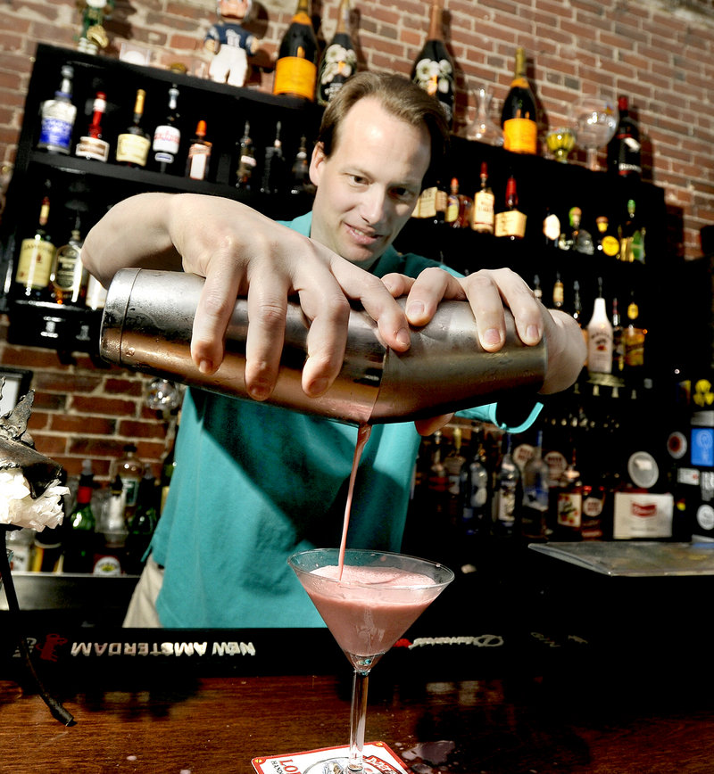 Slainte Wine Bar & Lounge owner and bartender Ian Farnsworth mixes and pours one of Slainte’s signature martinis – the PB & J.