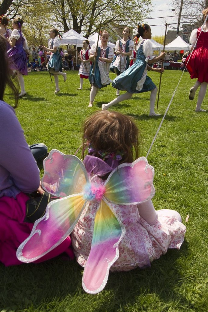A young fairy takes in the maypole dancing during last year’s May Day Festival in Kennebunk.