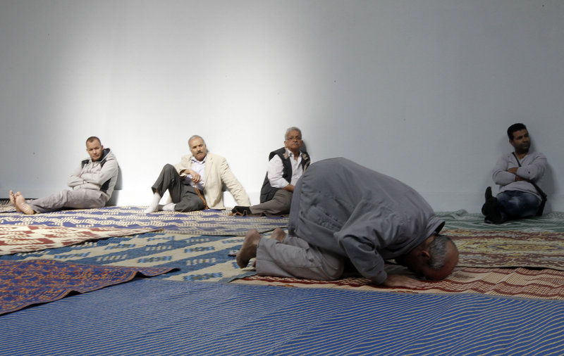 French Muslims attend prayer at a hall in an unused former fire station in Paris. There is a get-out-the-vote push among some Islamic groups in France.