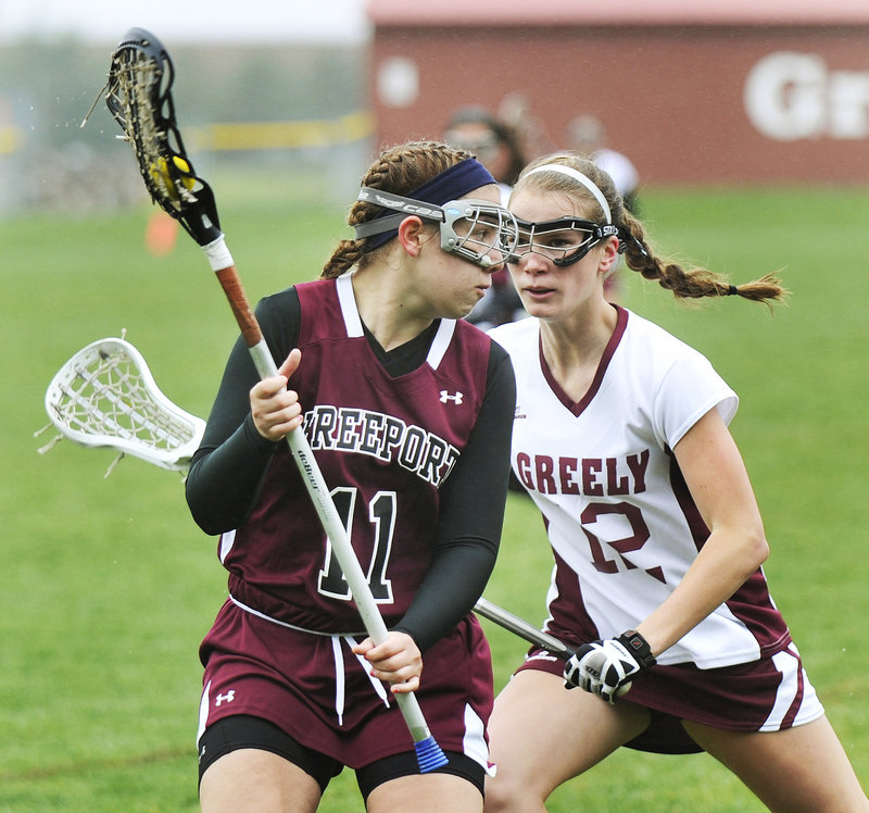 Kayla Thurlow of Freeport tries to get past Greely’s Teal Otley after scooping up a ground ball. Freeport used a 7-0 run in the second half to improve to 2-2.