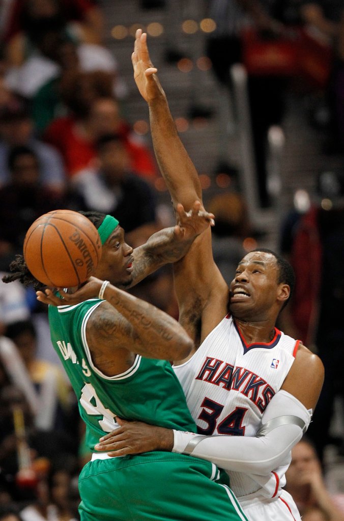 Marquis Daniels of the Celtics looks for an open teammate as Atlanta’s Jason Collins defends in Game 2 of the Eastern Conference quarterfinals Tuesday. Playing without Rajon Rondo, Boston rallied for an 87-80 win.