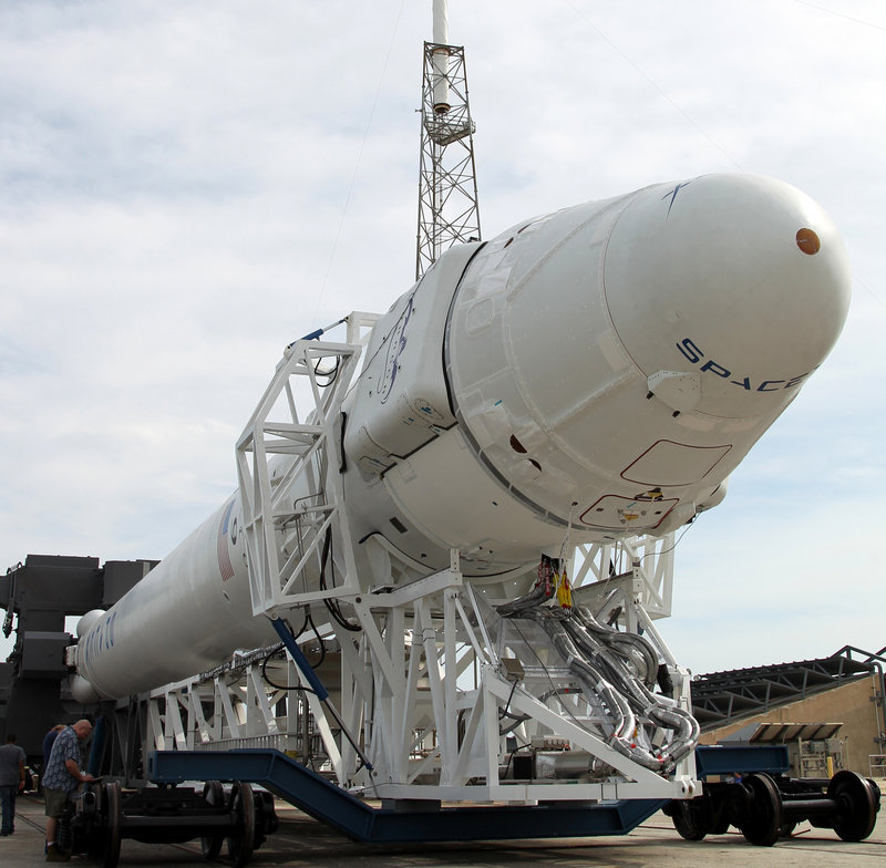 A SpaceX Dragon capsule on a Falcon rocket is transported to a launch pad in Cape Canaveral, Fla., earlier this week.