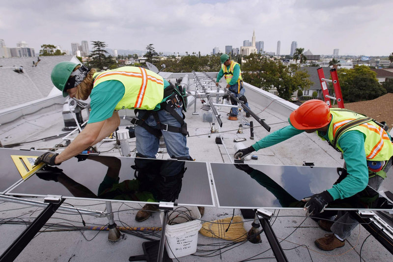 Workers for SolarCity, the nation’s largest solar power installer, set up thin-film panels on the roof of a home in Los Angeles. Most of the jobs in the U.S. solar industry are in installing, sales and distribution.