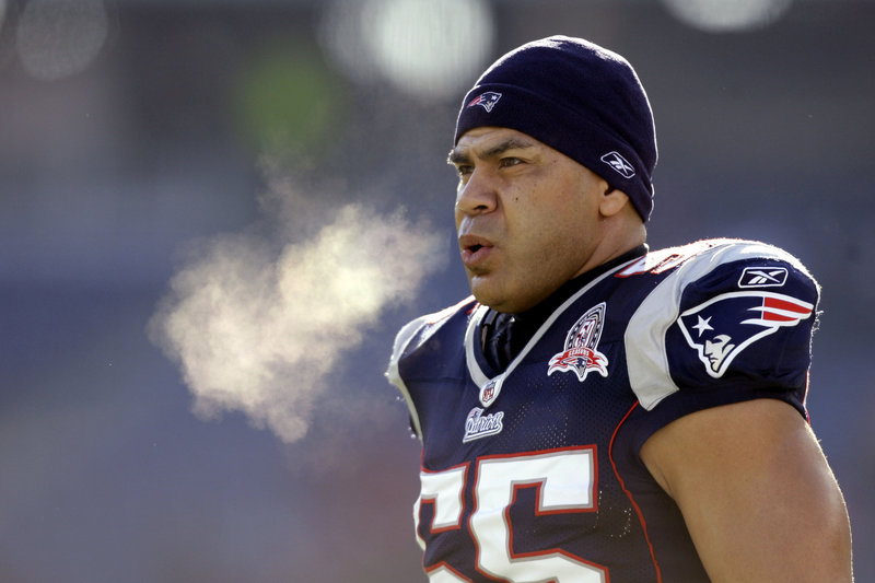 New England Patriots linebacker Junior Seau warms up on the field before an NFL wild-card playoff game in Foxborough, Mass., in 2010. Police say Seau was found dead at his home in Oceanside, Calif., Wednesday. He was 43.