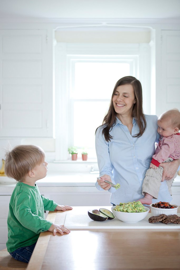 Amanda Bell, who owns Biddeford Saco Boot Camp, eats lunch with her children Simon, 2 1⁄2, and Grayson, 5 months, in her Biddeford kitchen.