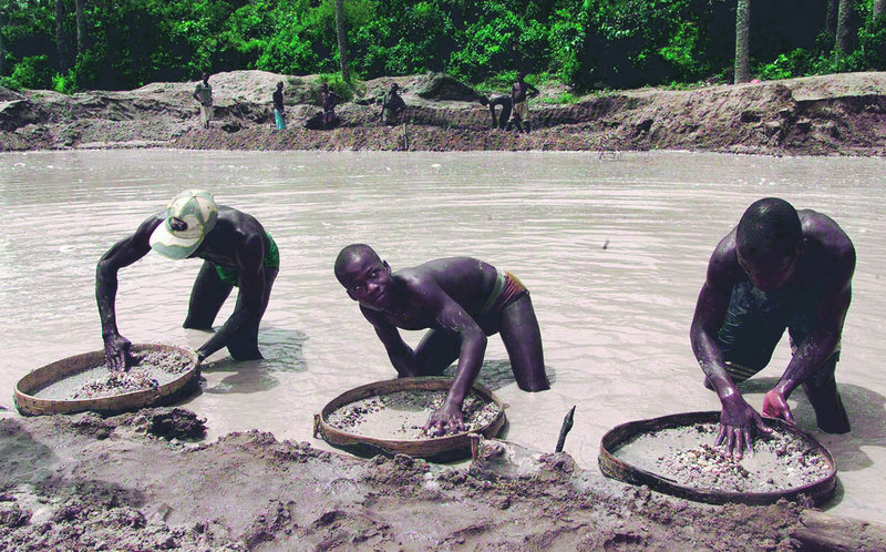 Diamond prospectors sift through the earth in the Corbert mine in Waiima, Sierra Leone, in this photo from 2000.
