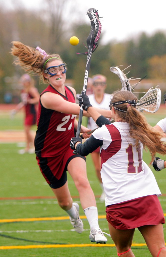 Lindsey Smith of Gorham gets off a shot while being defended by Nicole Moore of Thornton Academy during their game at Saco.