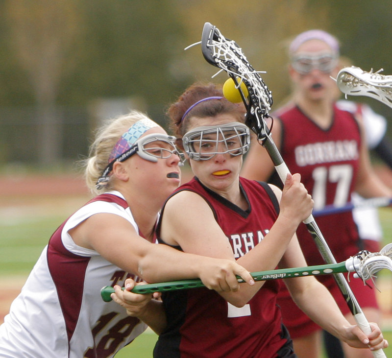 Kali St. Germain of Gorham is closely defended by Thornton Academy's Camilla Olsson in a lacrosse game Thursday in Saco. St. Germain scored four goals, and Gorham rallied for an 11-10 win.