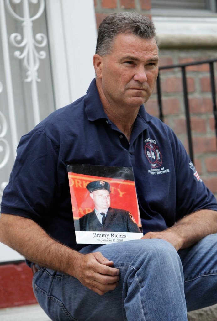 Retired firefighter Jim Riches with a photograph of his son near his home in New York on Thursday. His son was killed in the 9/11 terrorist attacks. Riches plans to watch the arraignments.