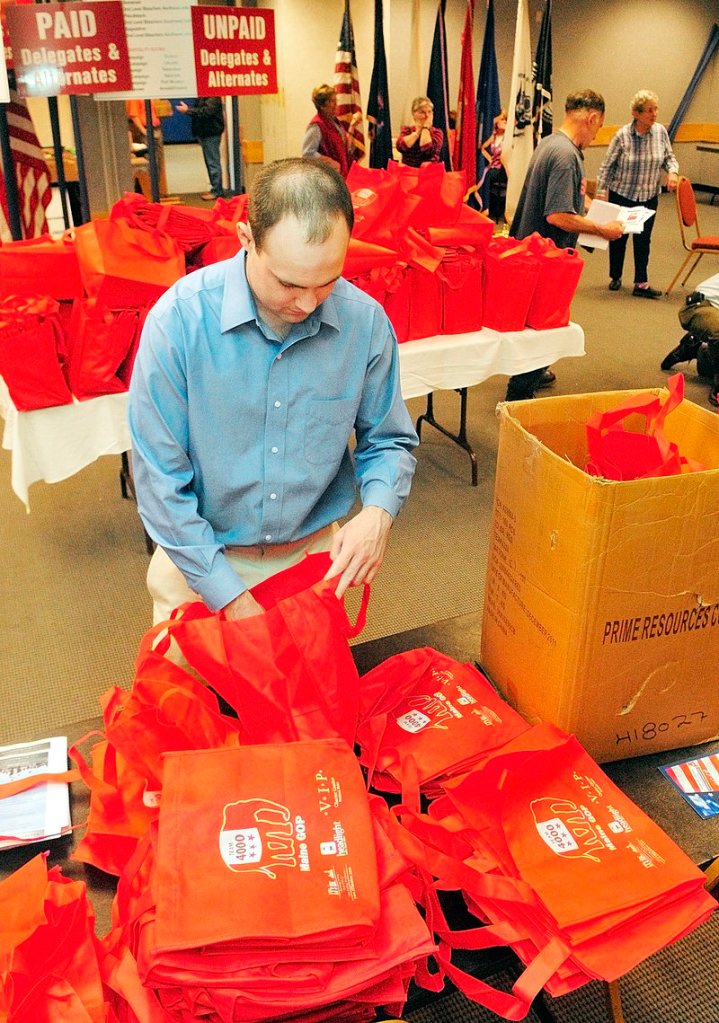 John McMahon, a volunteer for the Mitt Romney campaign from New Hampshire, on Friday puts leaflets into bags that will be given to GOP state convention delegates.