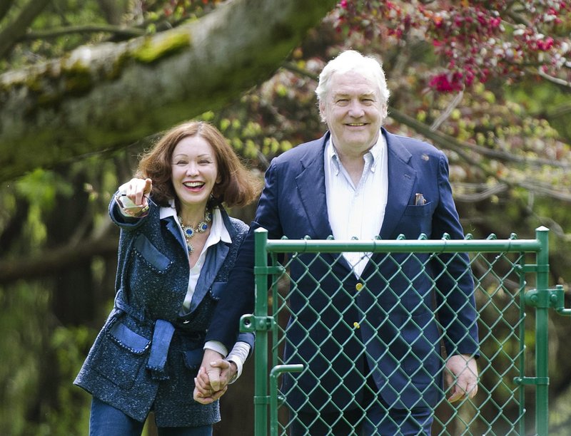 Conrad Black and his wife, Barbara Amiel Black, watch their two dogs in Toronto on Friday. Black was convicted of fraud and obstruction of justice charges in Chicago in 2007.
