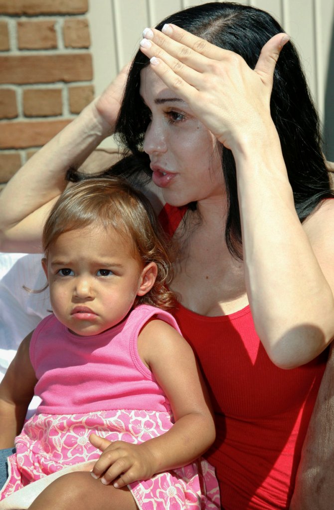 Photo from 2010 shows “Octomom” Nadya Suleman, holding her 20-month-old daughter Nariah Solomon, as she talks to the media about a yard sale and auction in La Habra, Calif.