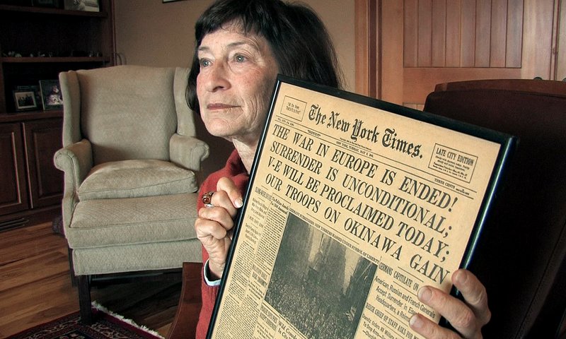 Julia Kennedy Cochran, daughter of former Associated Press Paris bureau chief Edward Kennedy, holds a copy of The New York Times published on May 8, 1945, at her home in Bend, Ore., on Wednesday.