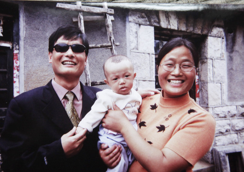 Chinese legal activist Chen Guangcheng and his wife, Yuan Weijing, hold their son in Shandong province. The United States and China forged the outlines of a deal Friday to end a diplomatic standoff over Chen that would let him travel to the United States with his family for a university fellowship.