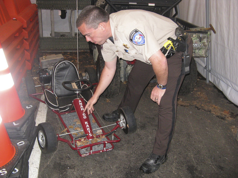 Lincoln County Sheriff’s Office Lt. Rand Maker points to frame damage on the go-cart driven by Marvin Tarbox, who was killed last year when the vehicle was in an accident while he was performing a stunt in the Damariscotta Pumpkinfest Parade.