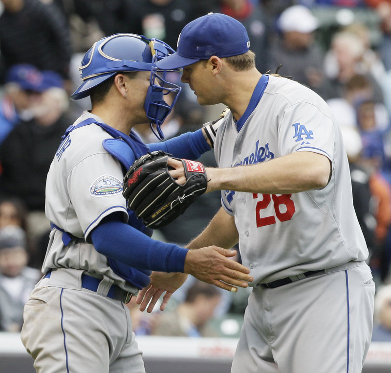 Jamey Wright and catcher Matt Treanor celebrate after the Dodgers beat the Cubs 5-1 Saturday at Chicago.