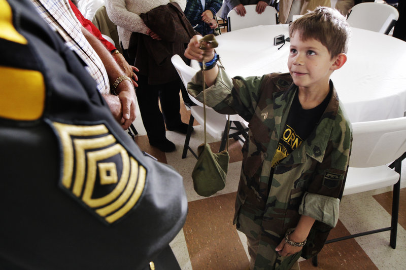 Jack McKibben, 7, of Cape Elizabeth acknowledges his grandfather, 1st Sgt. David Blouin, left, who received a silver star, like the one shown below, from the state for being wounded during the Vietnam War. A ceremony at the Maine Military Museum on Saturday paid tribute to dozens of service members and their families.