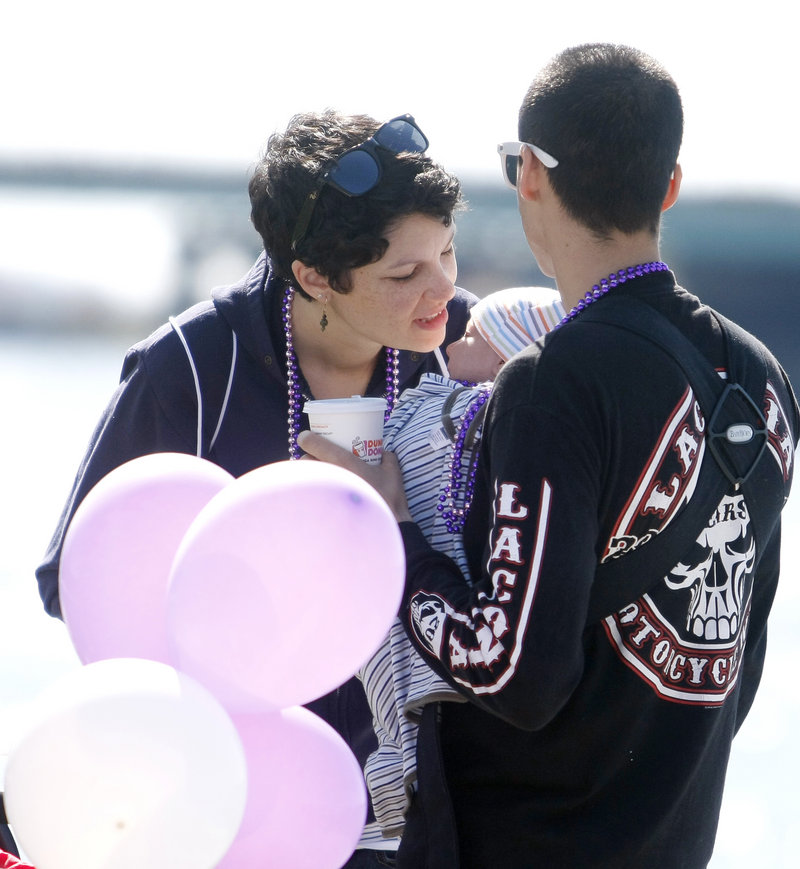 Miranda Wannemacher of Portland leans in to kiss her son, Levi, 6 weeks old, as she and her husband, Caleb, participate in the walk. As new parents, they felt inspired to walk in support of others.