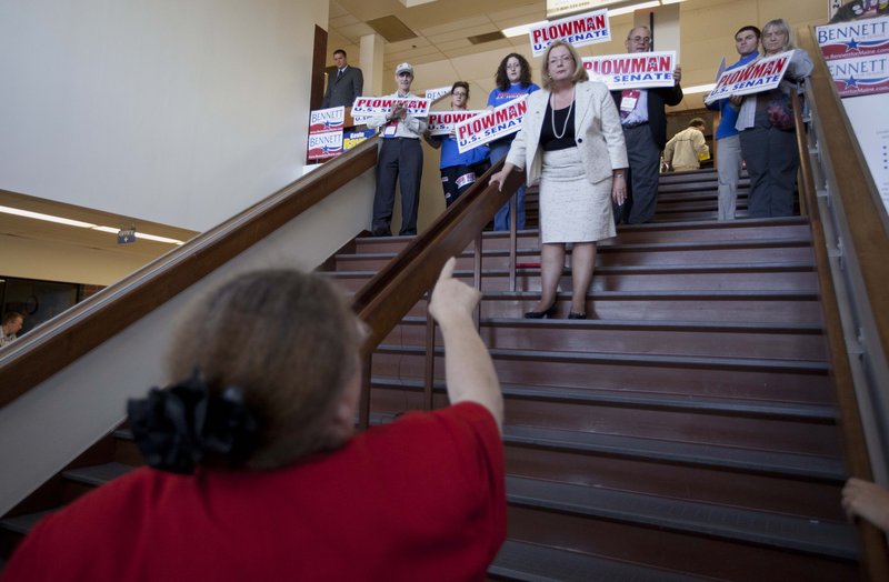 U.S. Senate candidate Debra Plowman takes a question while giving a speech from a stairway. Other Senate candidates whose speech time was eliminated did something similar.