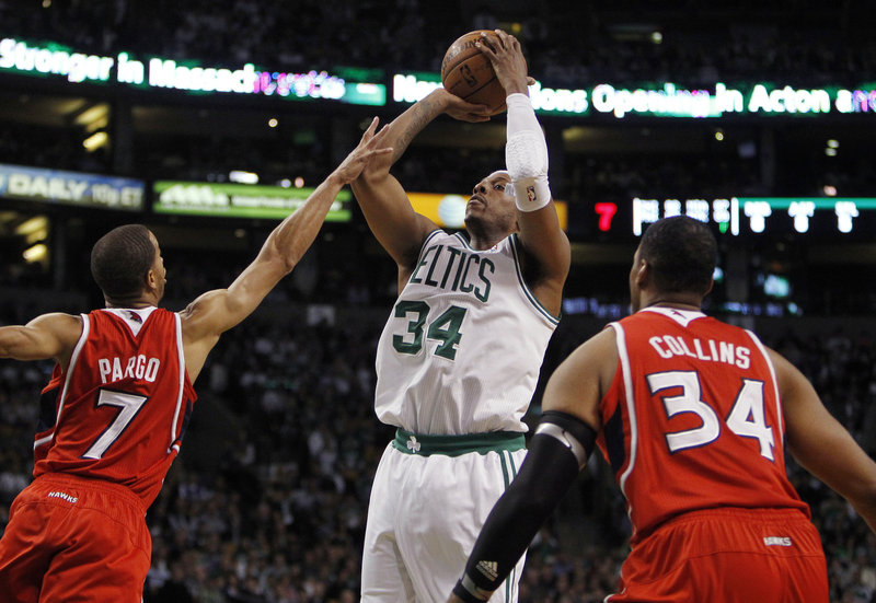 Paul Pierce goes up for a shot against Jannero Pargo of the Hawks as Jason Collins looks on. Pierce scored 24 points in just 18 minutes, getting some extra rest as Boston looks ahead to Game 5 in Atlanta on Tuesday night.