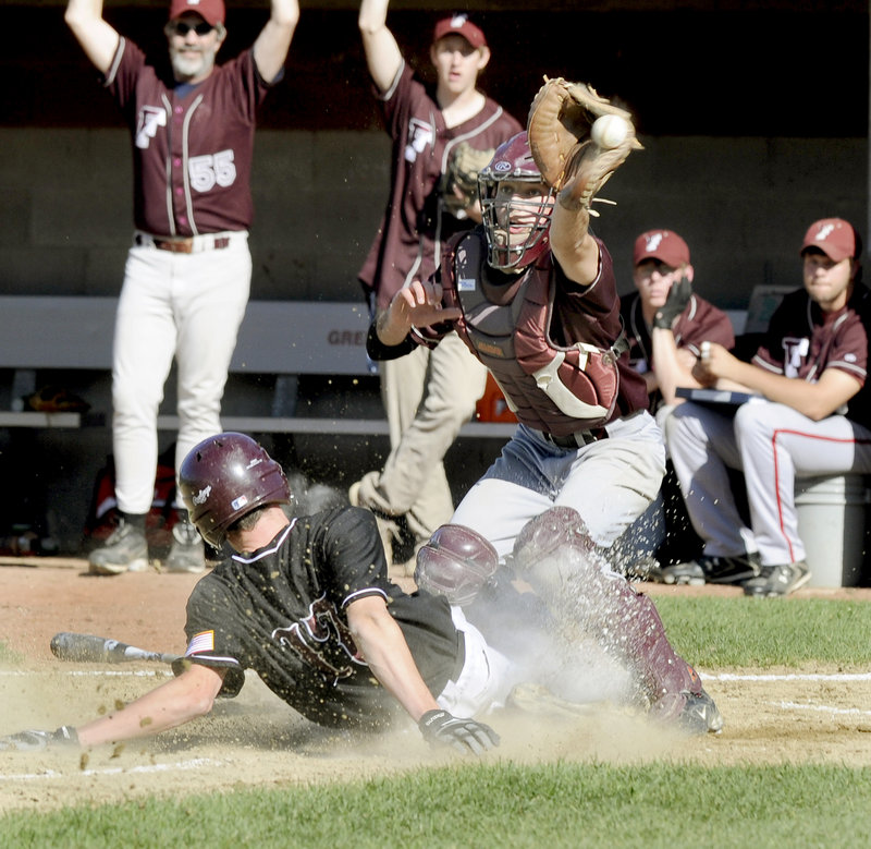 Sam Porter of Greely slides safely across the plate as Freeport catcher Jared Knighton can’t handle the throw in the third inning of Monday’s game in Cumberland. Two runs scored on the play, and Greely went on to a 4-2 win.