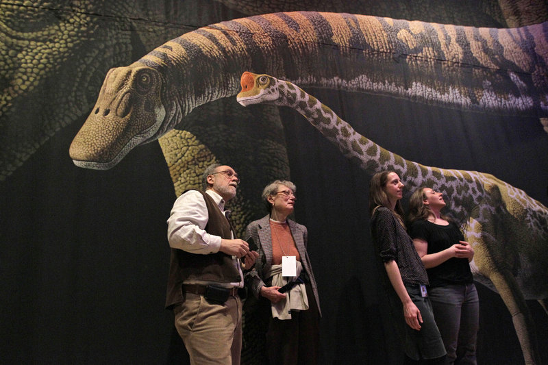 Visitors to the American Museum of Natural History in New York inspect a model of a 60-foot-long Mamenchisaurus, who likely produced greenhouse gases.
