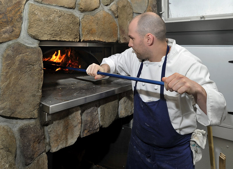 Kevin Walsh stokes the restaurant’s wood-fired oven.