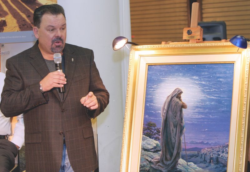 Artist Thomas Kinkade unveils his painting “Prayer For Peace” at the September 2006 opening of the exhibit “From Abraham to Jesus” in Atlanta.