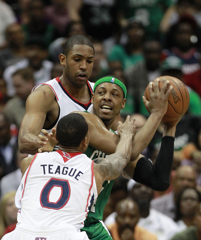 Paul Pierce of the Boston Celtics looks for room Tuesday night while hemmed in by Jeff Teague and Al Horford of the Atlanta Hawks. Atlanta won, 87-86.
