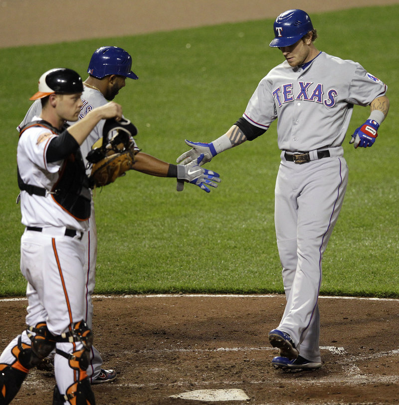 Josh Hamilton of the Rangers gets greeted at home after the third of his four home runs Tuesday night in Baltimore.