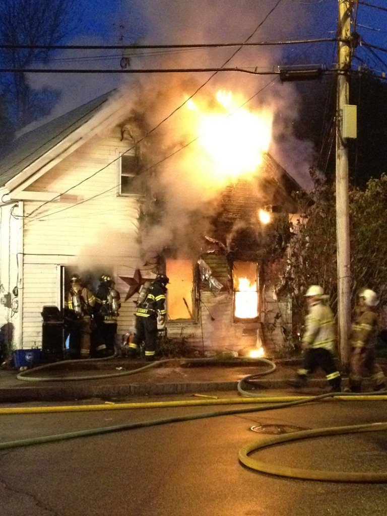 Fire engulfs a home at 55 Common St. in downtown Saco on Wednesday night. No one was injured in the blaze.