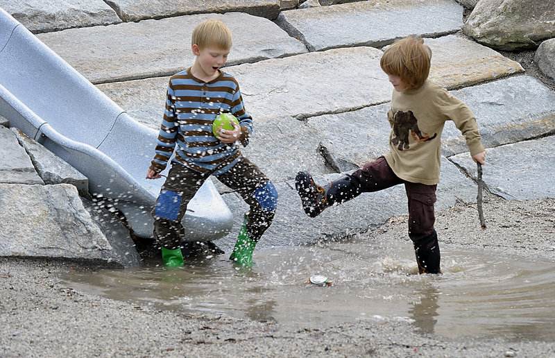 A big puddle and a slide presented a great combination for a splashing good time Thursday in Deering Oaks in Portland. Neil Gabrielson, 6, left, and friend Liam Spalding, 6, stirred things up with game of kick the can.