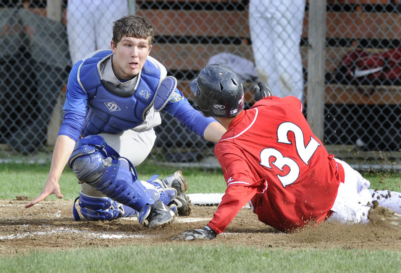 Lake Region catcher Tucker Irish makes the tag Thursday as Dan Quint of Wells slides into the plate during their Western Maine Conference baseball game at Naples. Wells earned a 5-3 victory.