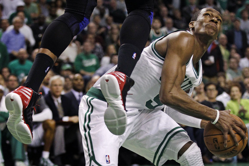 Rajon Rondo of the Boston Celtics ignores the feet to perform a feat. Puns aside, Rondo faked Josh Smith of the Atlanta Hawks more than a little out of position and headed to the basket during the second quarter of Boston’s series-clinching victory in Game 6.
