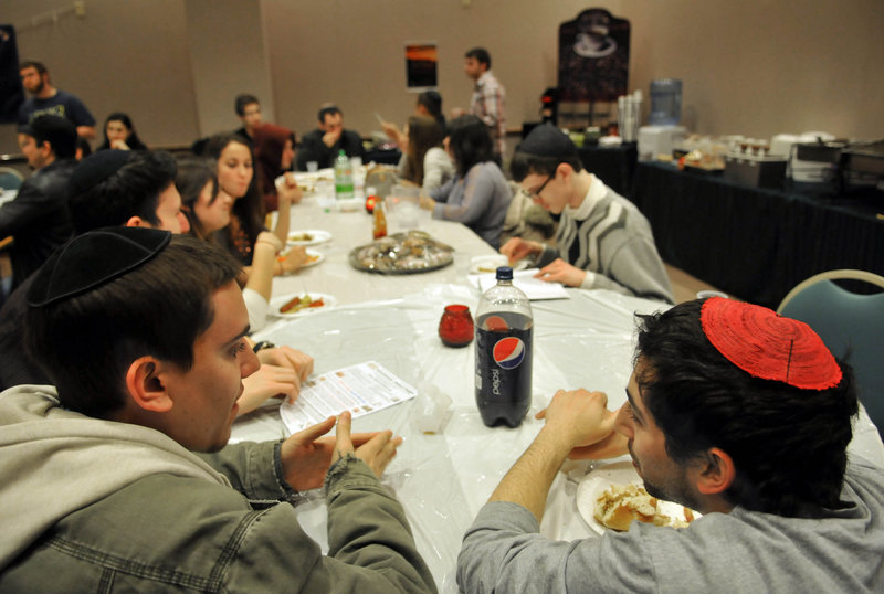 Students Matt Mantel, left, and Koby Sterman participate in a “pizza and philosophy” gathering at Chabad House at Rutgers University in New Brunswick, N.J. The Jewish group has staked out a prominent location.