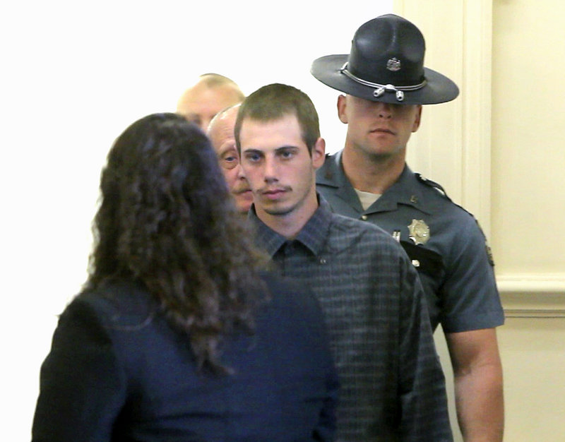 Gordon Collins-Faunce looks to his attorney, Amy Fairfield, while being led into a courtroom Friday at York County Superior Court in Alfred, where he was charged with depraved indifference murder in the death of his infant son, Ethan Henderson.