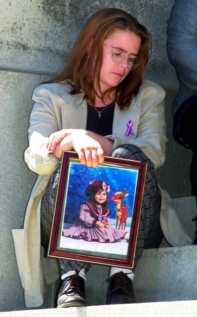 Logan Marr’s mother, Christy Reposa, holds a photo of her daughter, who was asphyxiated when she was duct-taped to a highchair while in foster care. Logan’s death launched reforms that began to trend toward removing fewer children from their families.
