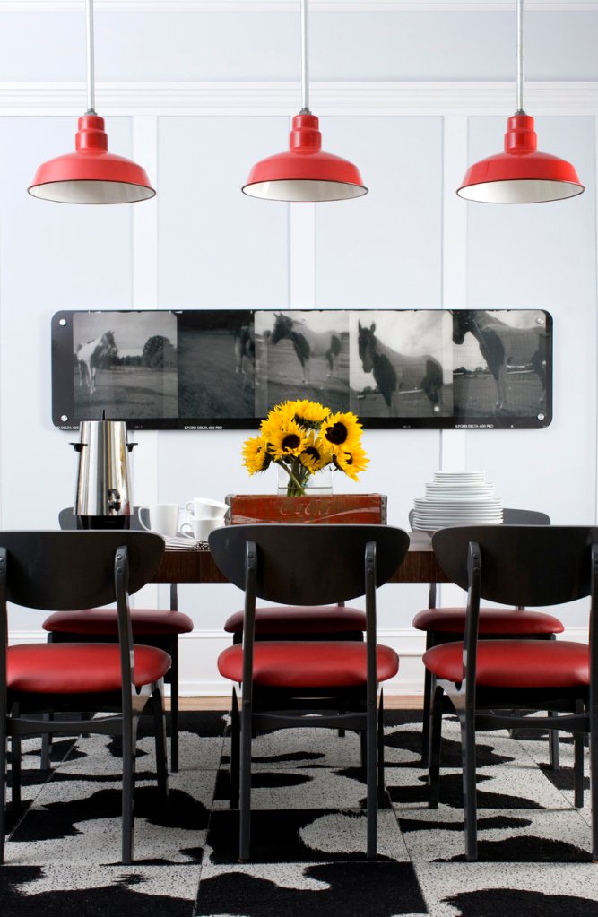 A dining room designed by Brian Patrick Flynn demonstrates how the designer balances space vertically by grounding a room with pendant lighting.