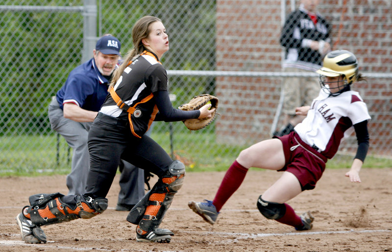 Biddeford catcher Katie Plante steps on the plate for a fcrceout as Haley Plante of Windham slides during their SMAA softball game Friday. Biddeford won, 5-2.