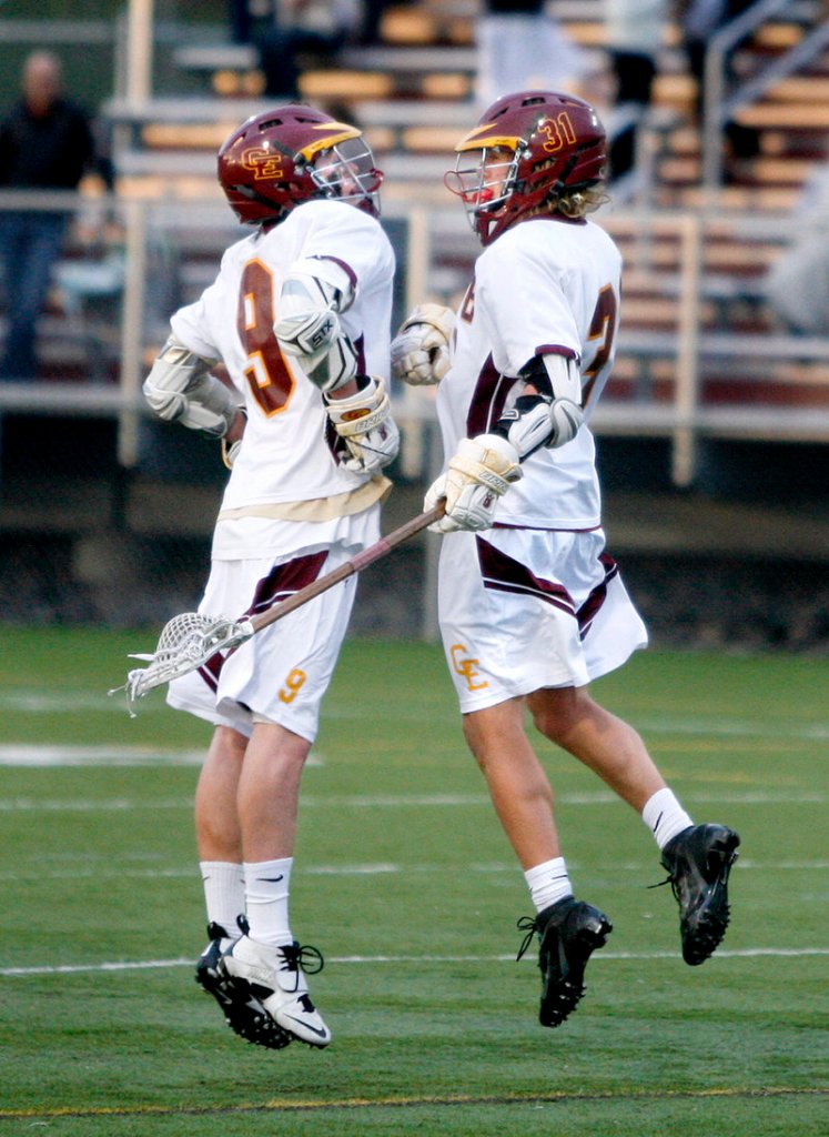 Alex Bornick of Cape Elizabeth, right, chest-bumps with Tom Bottomley after scoring in the second period Friday night in a 12-2 victory against Cheverus. The Capers improved to 7-0 in boys’ lacrosse.