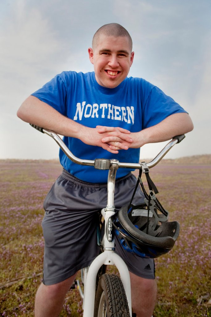 Ian Wells sits on his bike in North Hanover, N.J., last year. Wells, now 21, has autism and has had trouble finding paid employment.