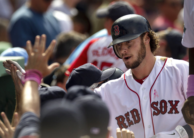 Jarrod Saltalamacchia returns to the Boston dugout after hitting a two-run homer in Sunday’s game at Boston. Saltalamacchia had five RBI in the 12-1 win.