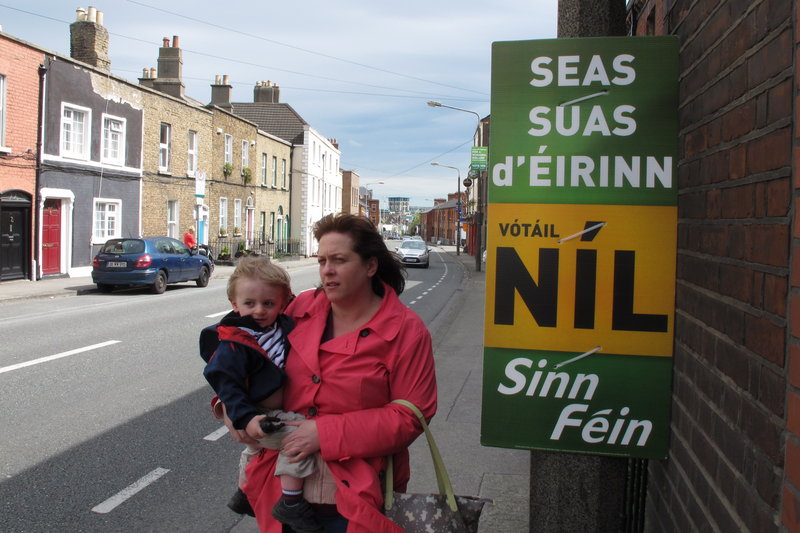 A mother and child walk past a poster urging a "no" vote in Ireland's referendum on the EU fiscal treaty in Dublin on Sunday. The poster says in Gaelic: "Stand up for Ireland, vote no.'' Ireland's May 31 vote represents the only popular test for the 25-nation treaty.