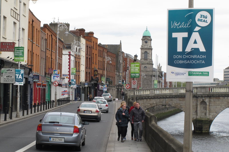 Referendum posters line a riverside street in Dublin Sunday. The Irish government is asking voters to approve the European Union's fiscal treaty in a May 31 vote. The poster in the upper right advises "Ta," which is Gaelic for "yes."