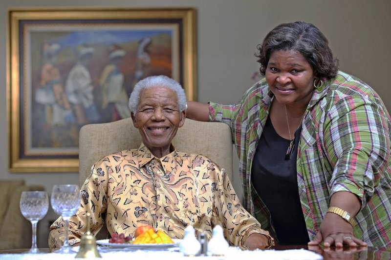 Nelson Mandela, left, the former president of South Africa, spends time with his personal chef, Xoliswa Ndoyiya. The chef is sharing the home cooking that Mandela loves in a new cookbook.