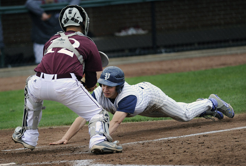 Tim Rovnak of Portland tries to score, but is blocked off the plate by Windham catcher Jack Herzig in Monday’s baseball game at Hadlock Field. Windham won 8-3 as Shawn Francouer had four hits and three RBI.